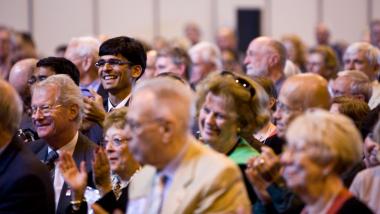 Rotary Peace Fellow Dashan P. Mundada claps at the Rotary World Peace Symposium after Archbishop Desmond Tutu's speech. 