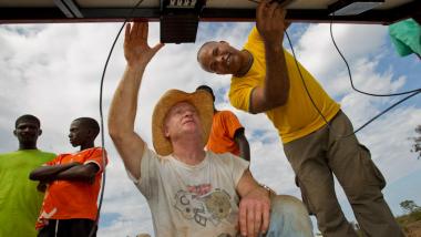 Rotarian Community members of Nan Semma on La Gonave, Haiti install solar panels onto the roof of the local clinic.