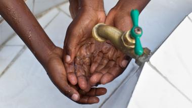 School children wash their hands a fountain provided by Rotary International at an elementary school in Les Cayes, Haiti. Photo by Alyce Henson/Getty Images.